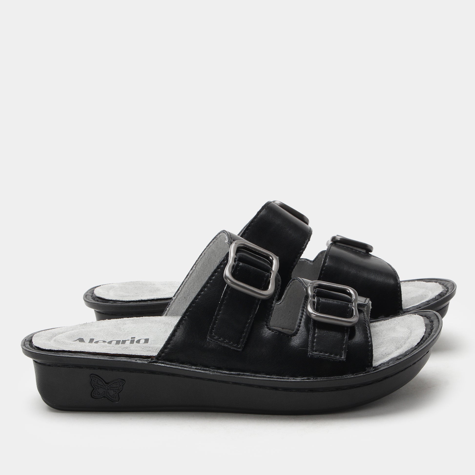 Black sandal with two buckles on a white background