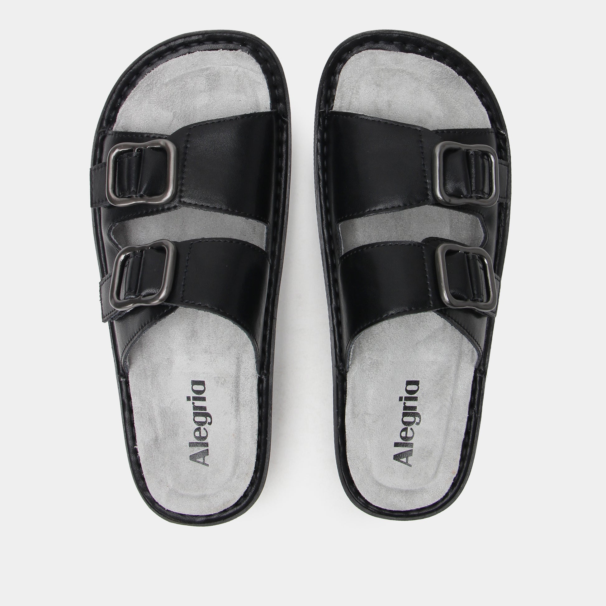 Black sandals with buckle straps on a white background, featuring the brand 'Alegria'.