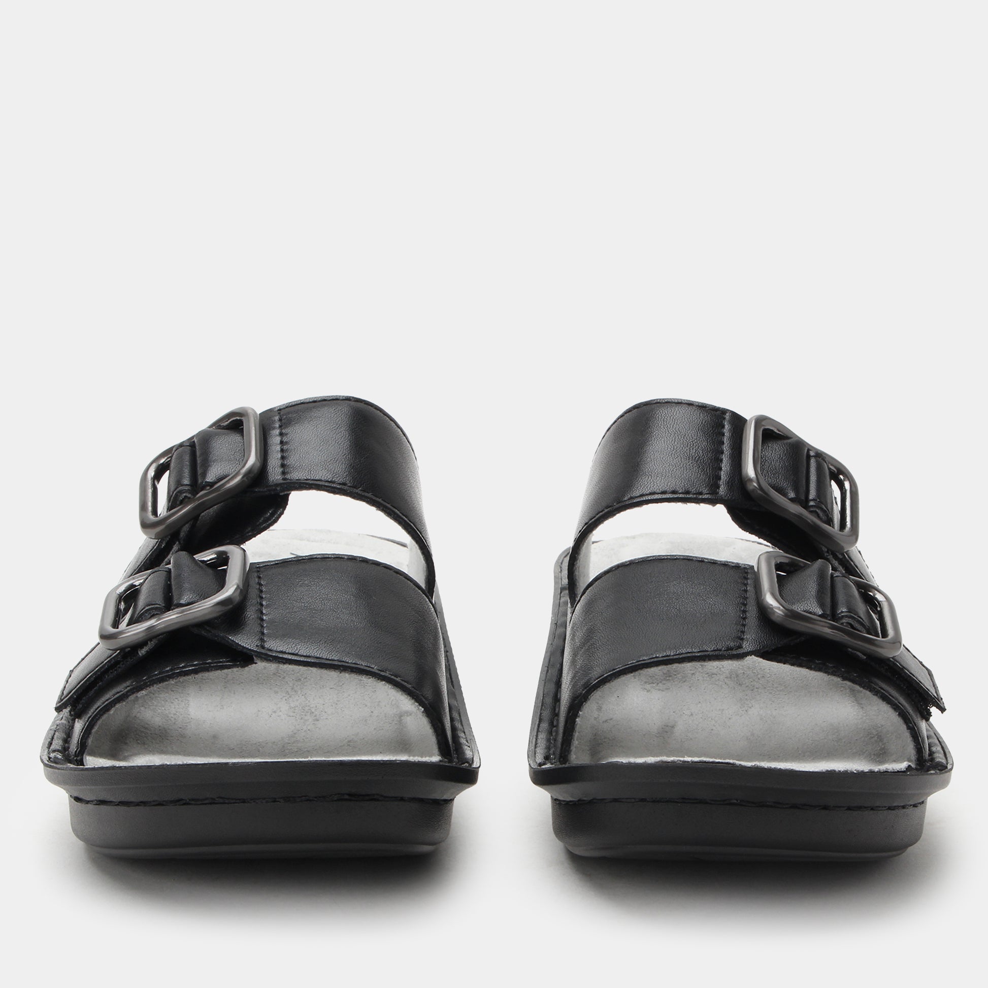Black sandals with multiple straps on a white background