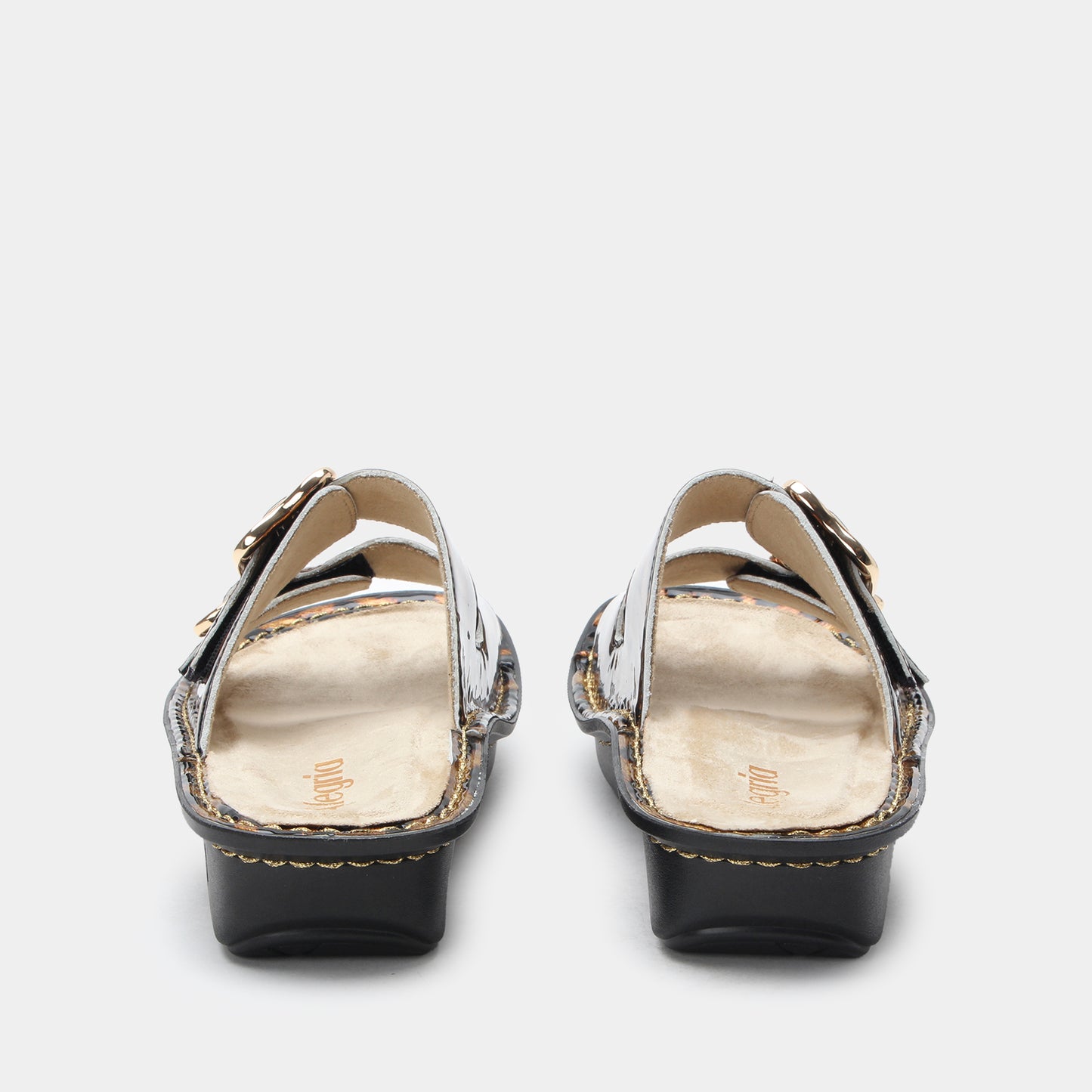 Pair of black high-heeled shoes with gold accents on a white background