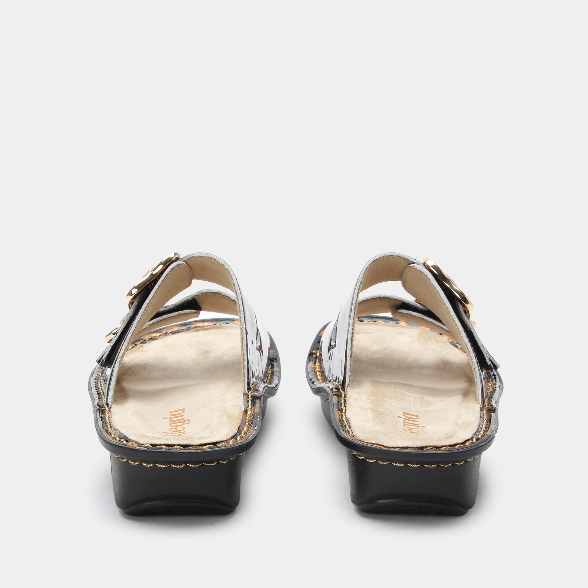 Pair of black high-heeled shoes with gold accents on a white background