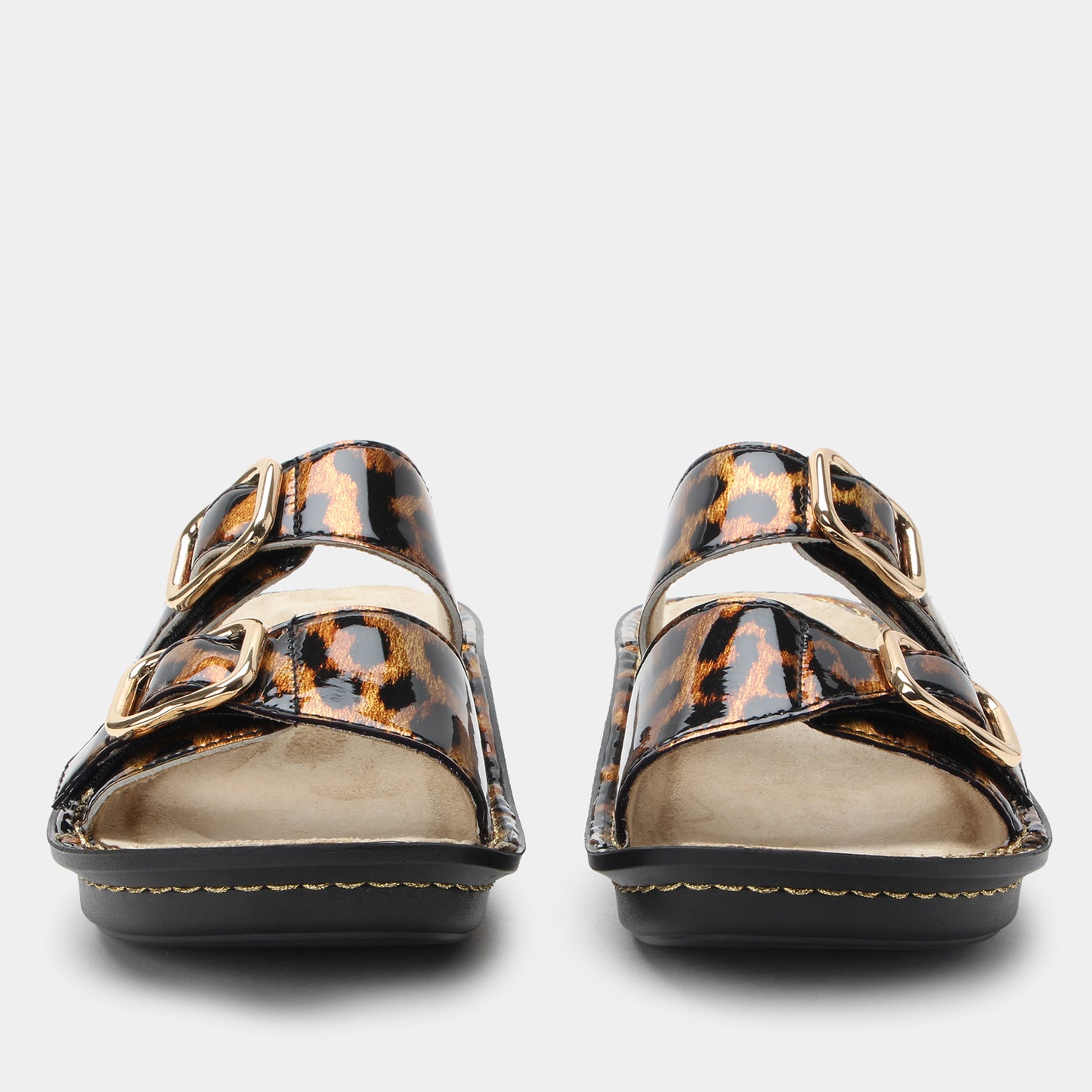 Pair of leopard print sandals on a light gray background