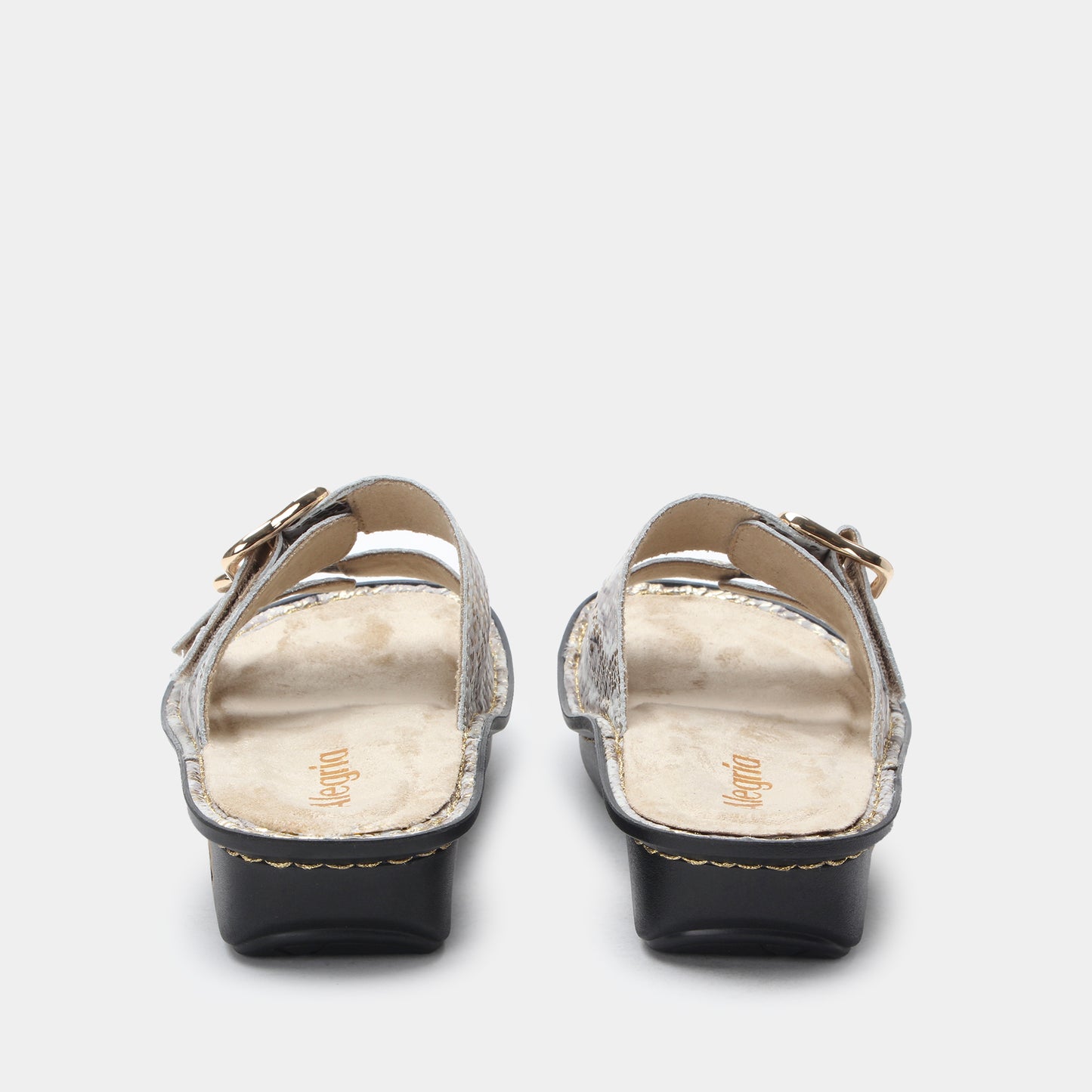 Pair of black sandals with gold straps on a white background