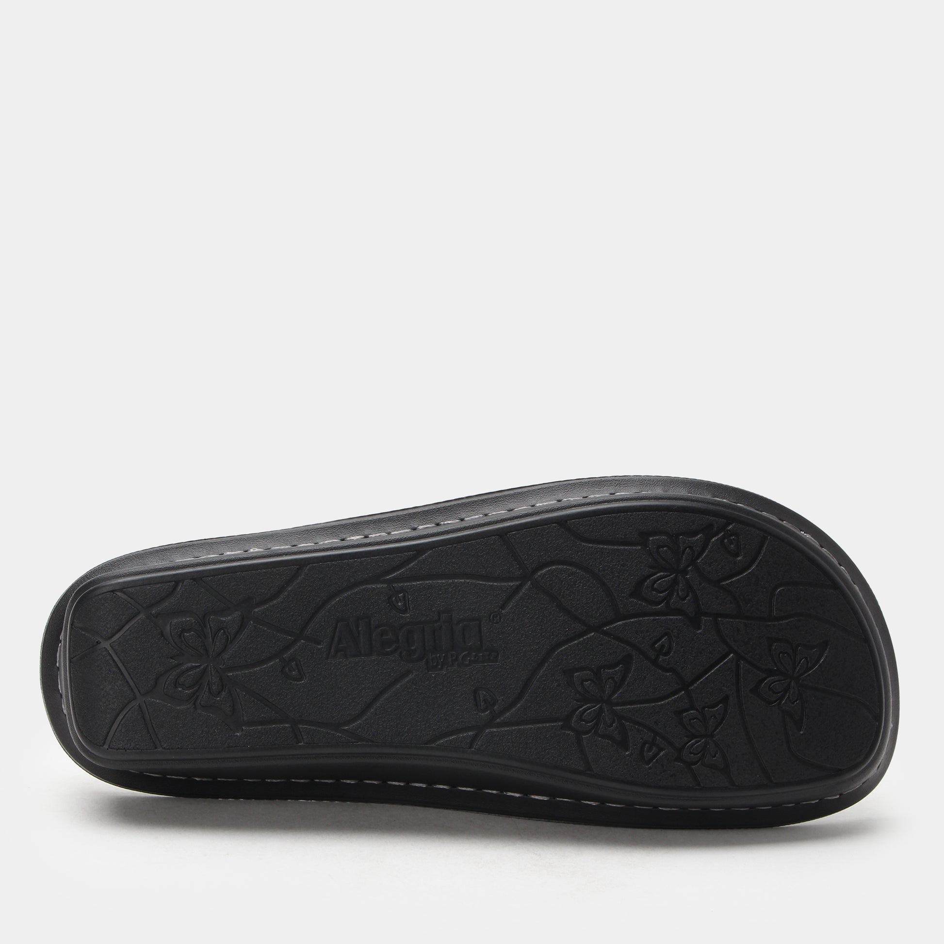Black sandal sole with floral patterns on a white background