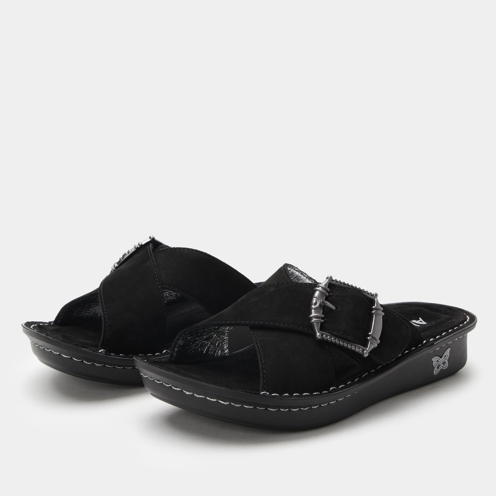 Pair of black sandals with buckles on a white background
