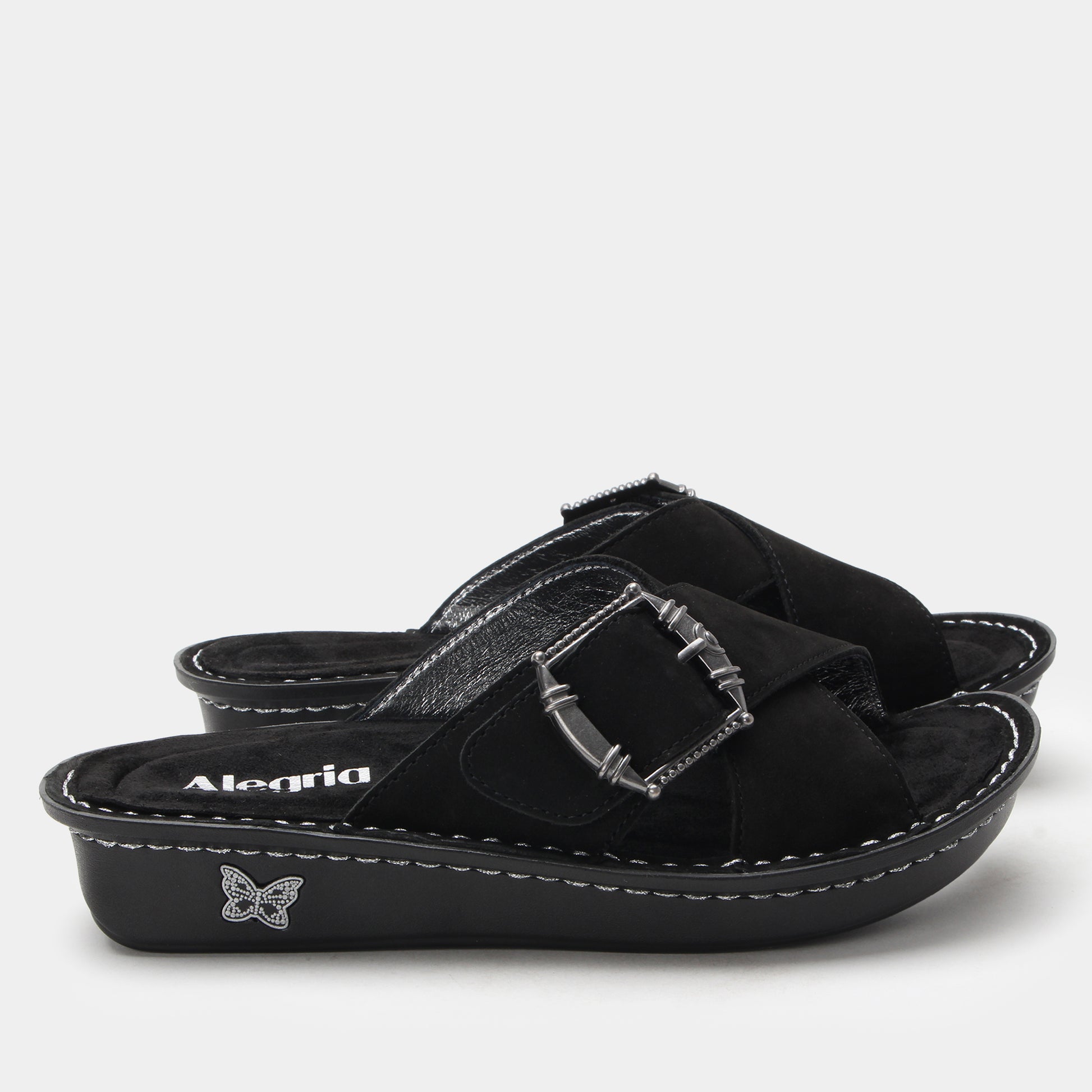 Black sandal with a buckle on a white background