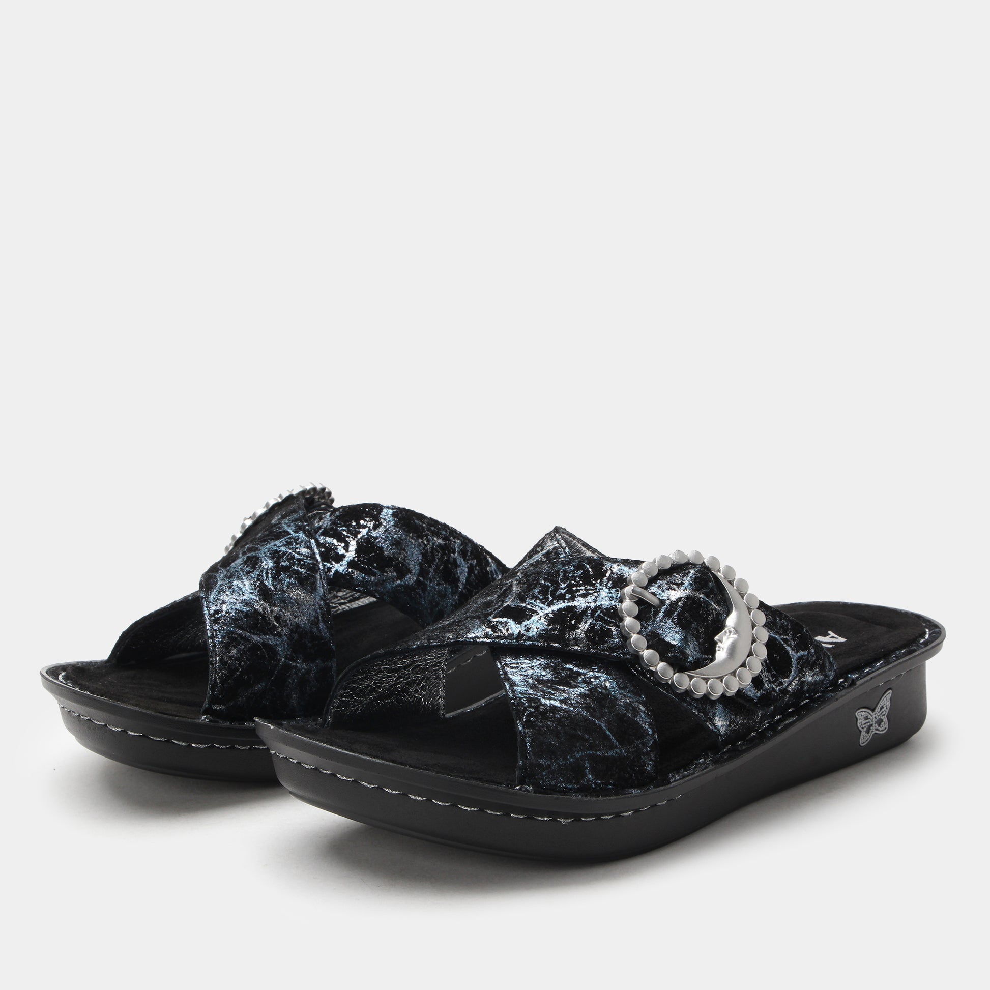 Black marble-patterned sandals with a decorative strap on a white background