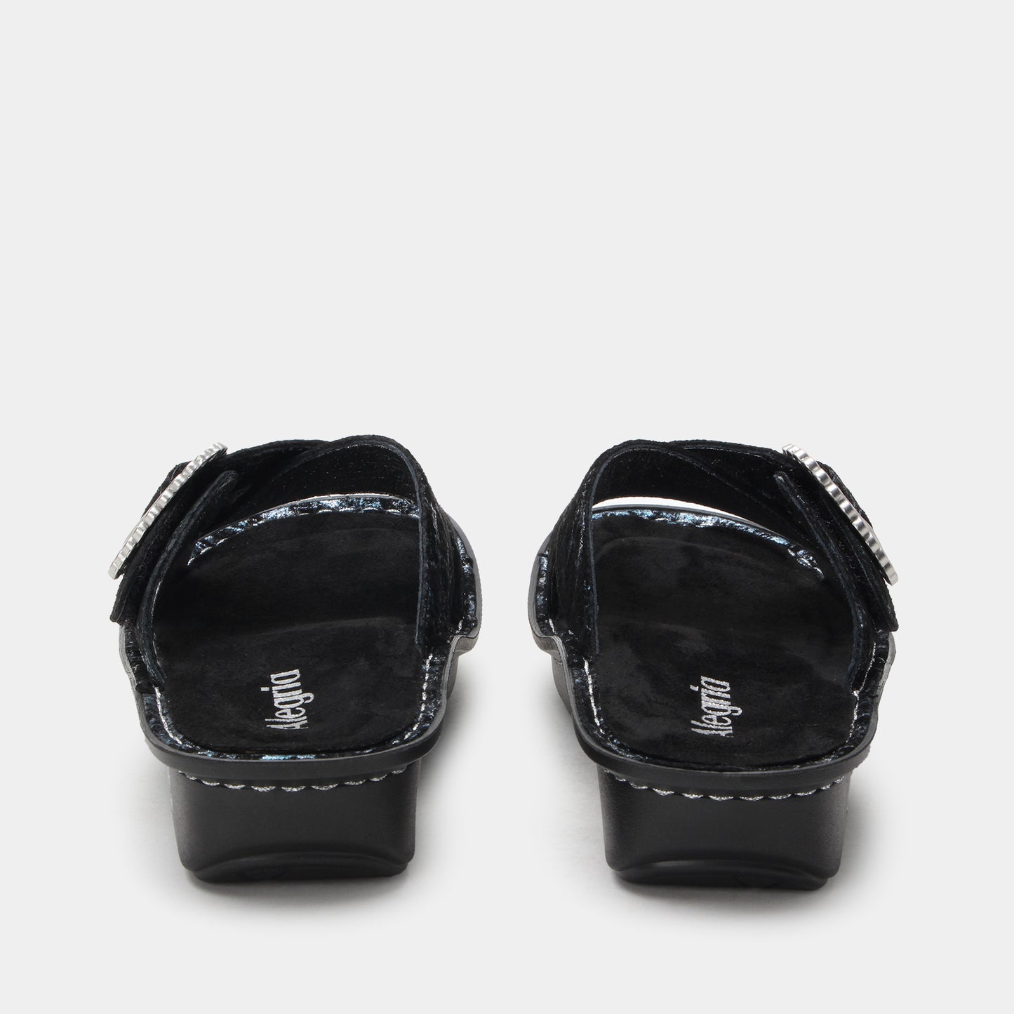 Black sandals with decorative straps on a white background