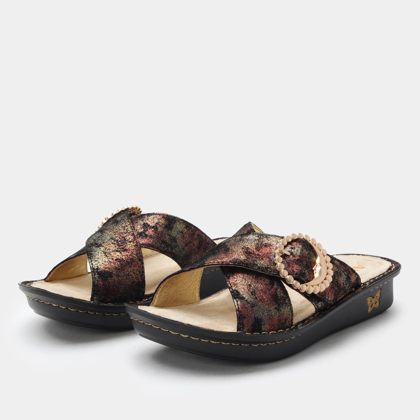 Pair of patterned sandals on a light gray background