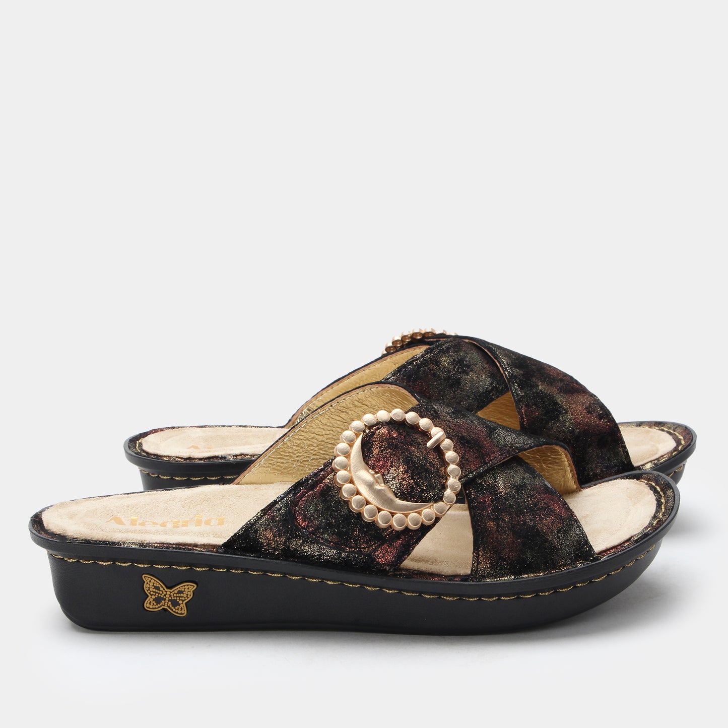 Black sandal with floral pattern and pearl embellishment on a white background