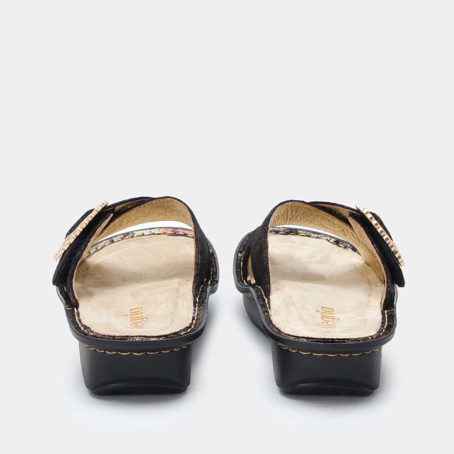 Black sandals with gold trim on a white background