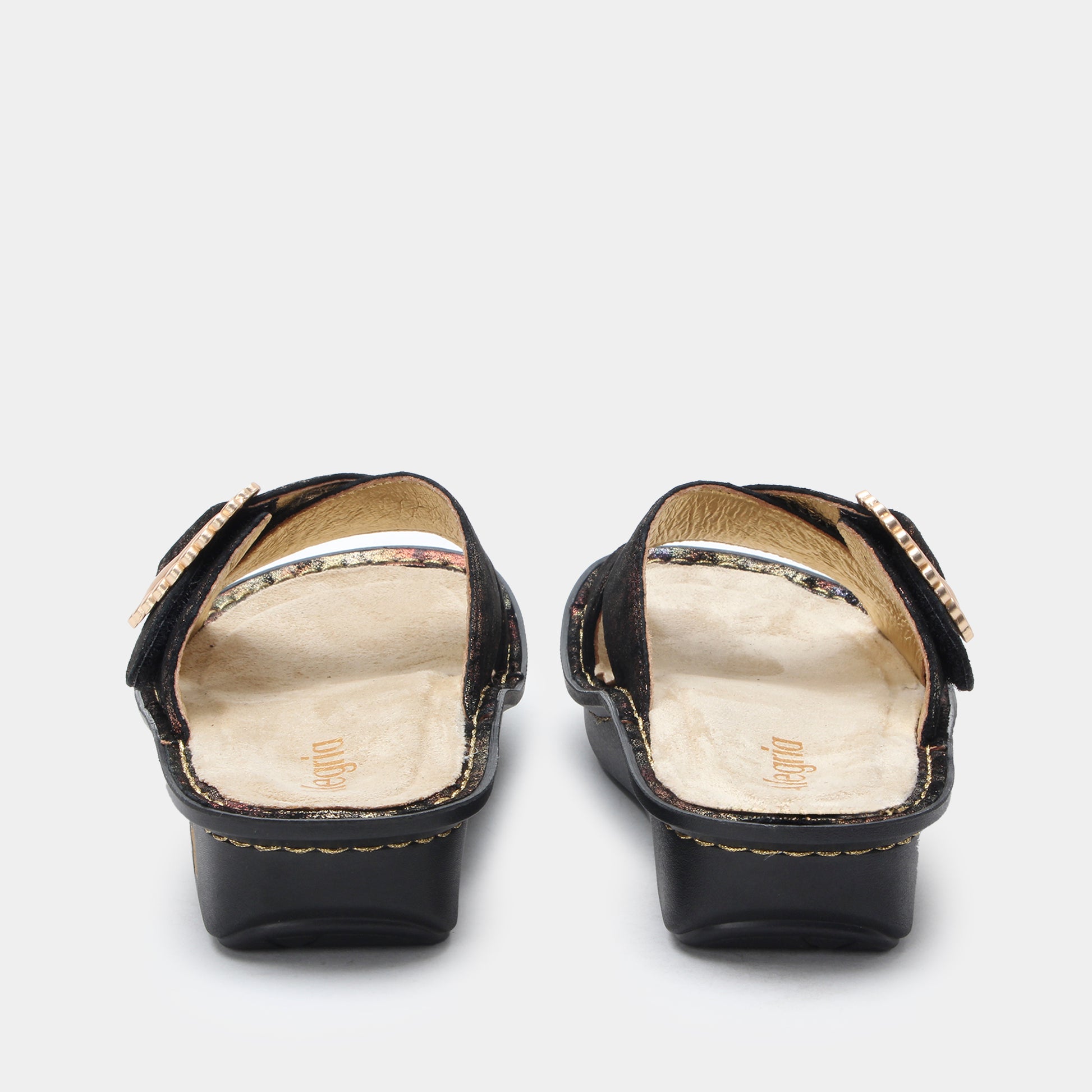 Black sandals with gold trim on a white background