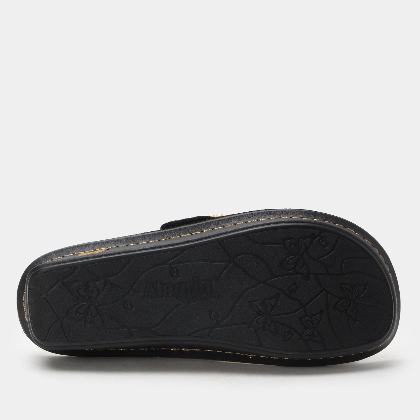 Black sandal sole with brand logo on a light gray background